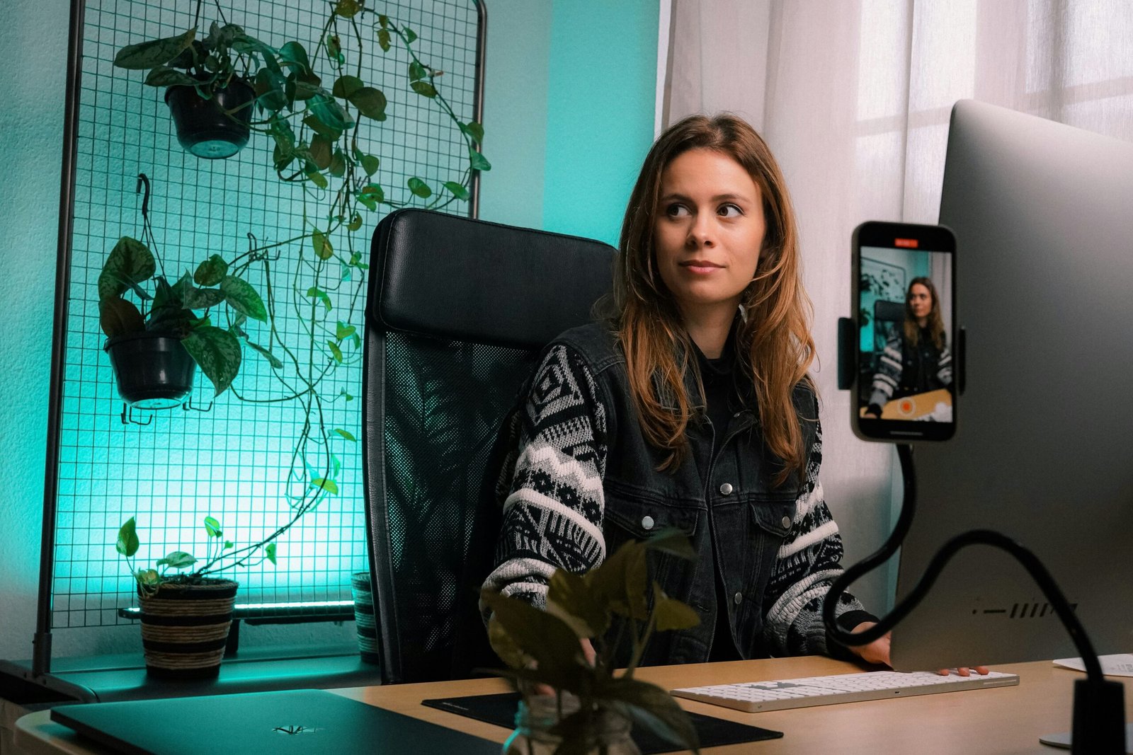 woman in black and white zip up jacket sitting on black office rolling chair